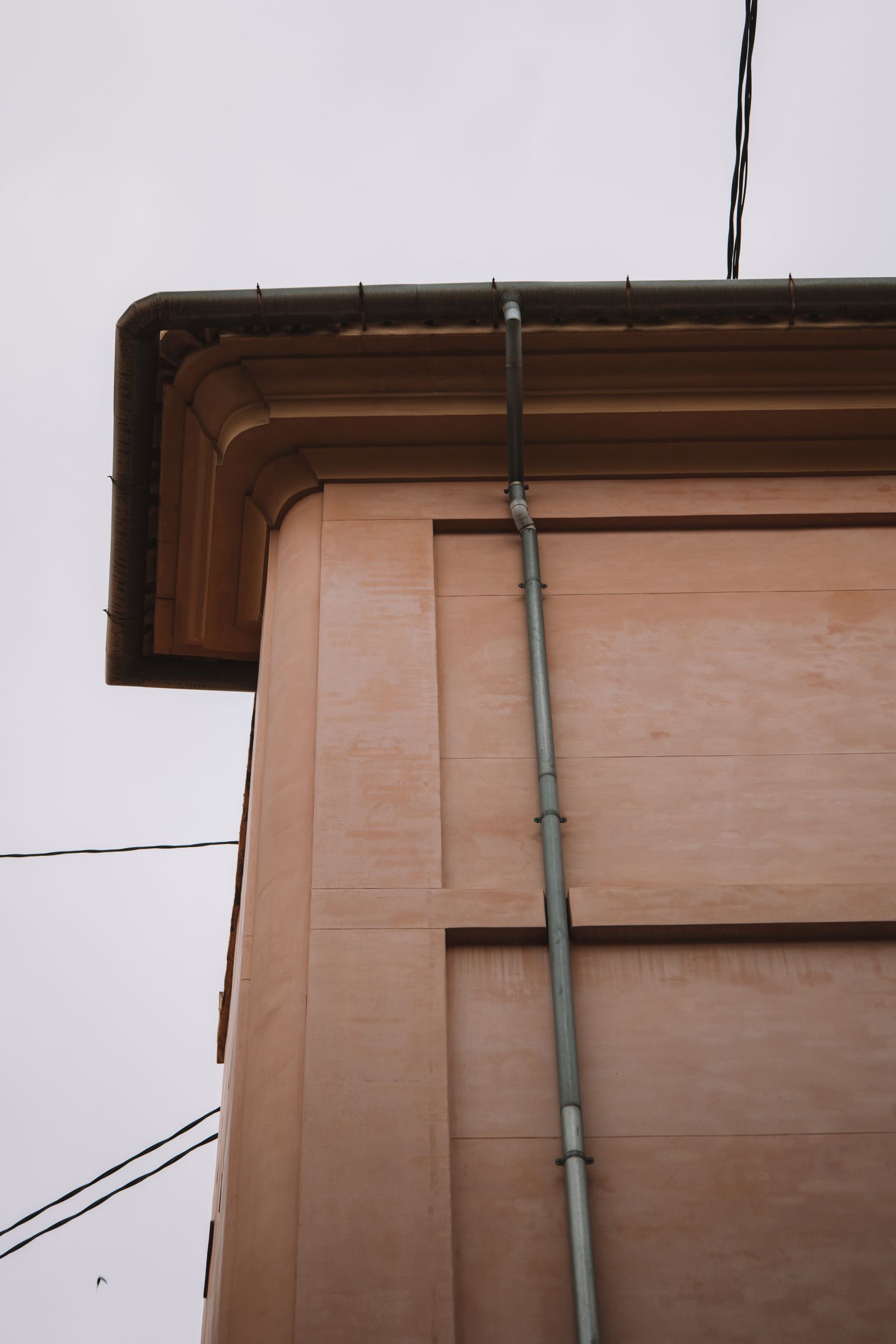 Gutter running into a downspout at the corner of a building